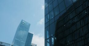 A tall building with a lot of windows next to another building