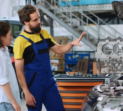 mechanic shows client car parts hologram