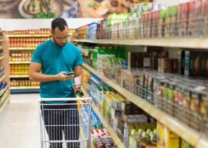 focused african american man reading shopping list smartphone